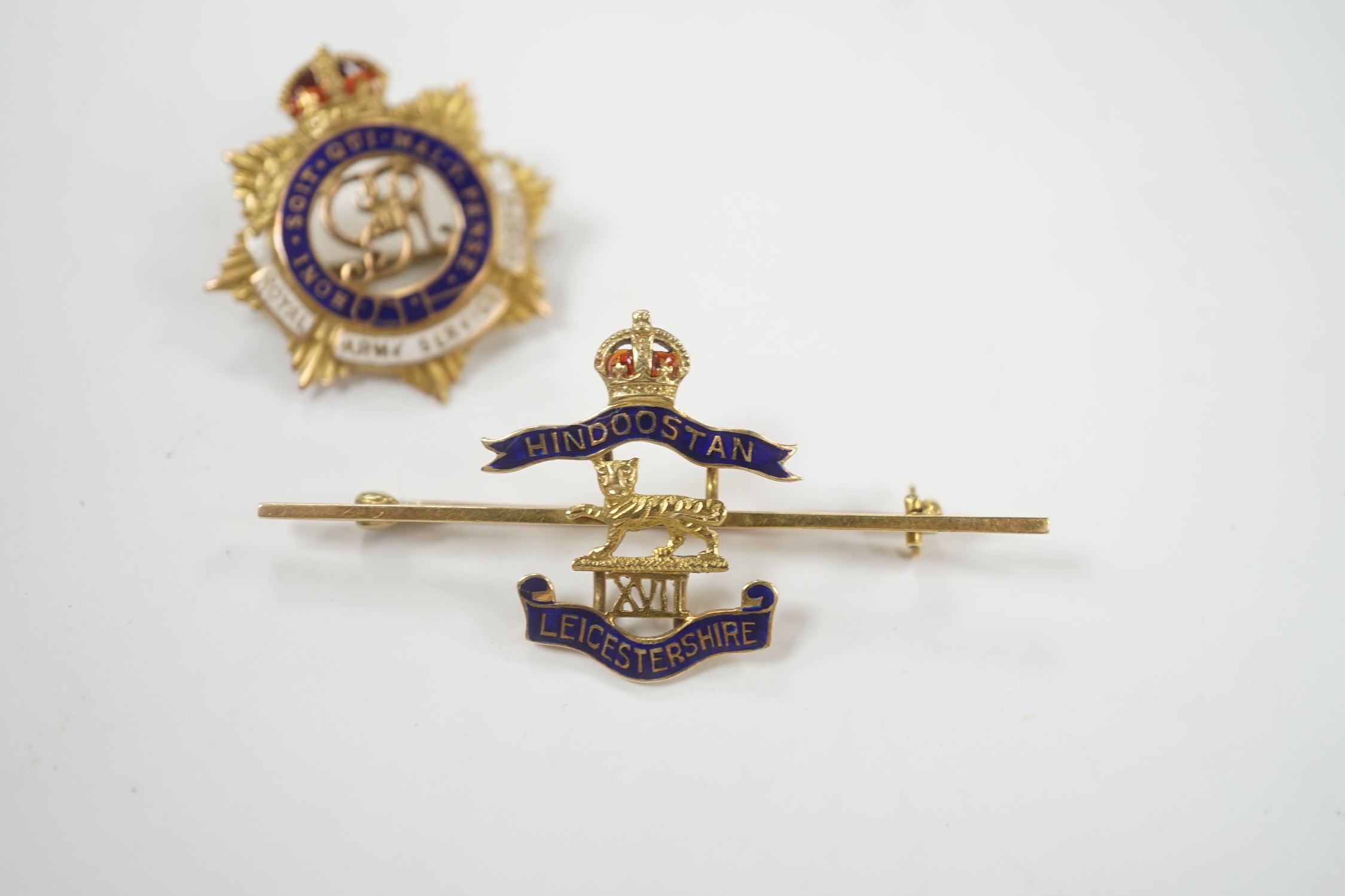A 14ct and two colour enamel Royal Leicester Regiment sweethearts brooch, 50mm and a 9ct and enamel Royal Army Service Corps badge.